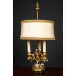 A decorative table lamp constructed from a 19th century gilt metal three branch candelabrum, applied