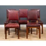 A set of five red leather dining chairs, the upholstered seat and seat back with brass stud edges on