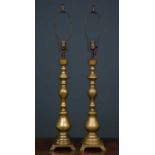 A pair of brass table lamps converted from oil lamps, the stems on square pedestal base, 68cm high