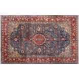 A Middle Eastern Karajeh woollen rug with banded border and stylised foliate decoration, 210cm x