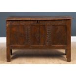 An 18th century oak chest with three panelled front and fitted with a candle box within, 110cm