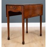 A George III mahogany small size Pembroke table the quarter veneered top with central boxwood