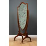 An Edwardian mahogany inlaid shield shaped cheval mirror, 66.5cm wide x 154.5cm high x 44cm deep.