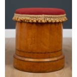 A Victorian cylindrical satin birch commode stool with overstuffed upholstered seat, lifting to