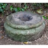 An ancient round stone quern with partial rim, 47cm diameter x 15cm highCondition report: very