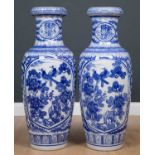 A pair of large blue and white Chinese porcelain vases, each decorated with two oval panels