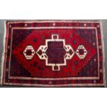 A Middle Eastern red ground rug with geometric decoration, 250cm x 173cmCondition report: Moderate