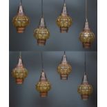 A set of eight 20th century Venetian patinated metal lanterns, the shaped amber-coloured glass