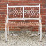 A white painted cast iron two seater garden bench, the geometric decorated back above strapwork