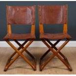 A pair of designer hardwood side chairs with leather seats and X framed stretchers, with Starbay