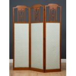 An Edwardian painted satinwood three fold screen with pierced ornament, inset with fabric panels,