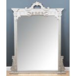 A large contemporary Victorian style grey painted overmantle mirror with arching carved cresting,