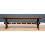 A Victorian oak bench with shaped end supports and trefoil punched stretcher, 153cm long x 30cm deep