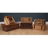 A selection of nine wicker baskets, four lidded picnic style baskets and five open topped with