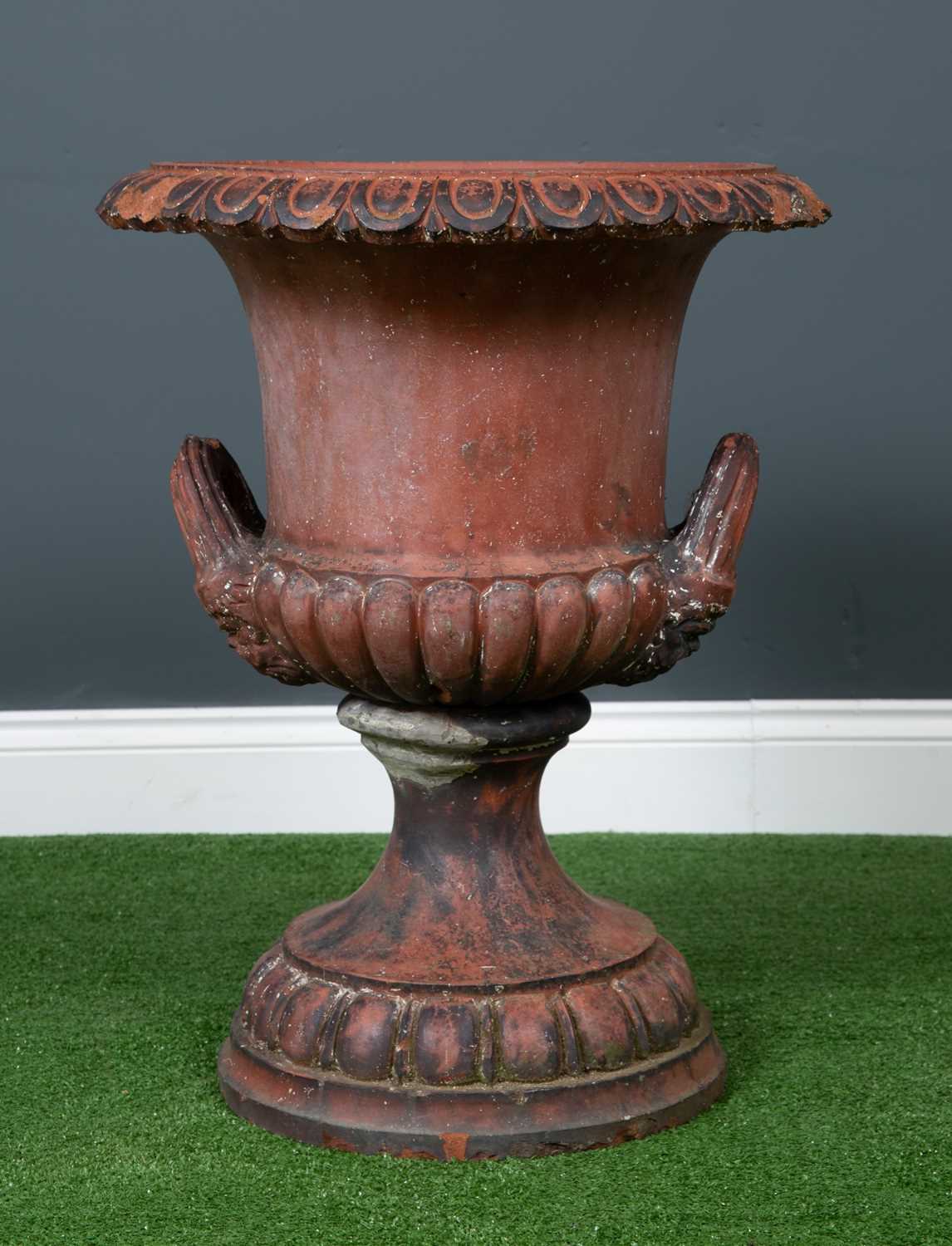 A Victorian or Edwardian terracotta urn of campana form with egg and dart decorated rim, mask