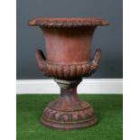 A Victorian or Edwardian terracotta urn of campana form with egg and dart decorated rim, mask