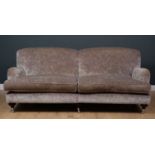 A contemporary large sofa with grey upholstered deep seat and turned tapering front legs terminating