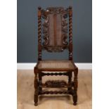 A 17th century walnut high backed side chair with crown decoration to the cresting rail and back,