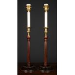A pair of George III style mahogany and brass table lamps, the fluted wooden column topped with