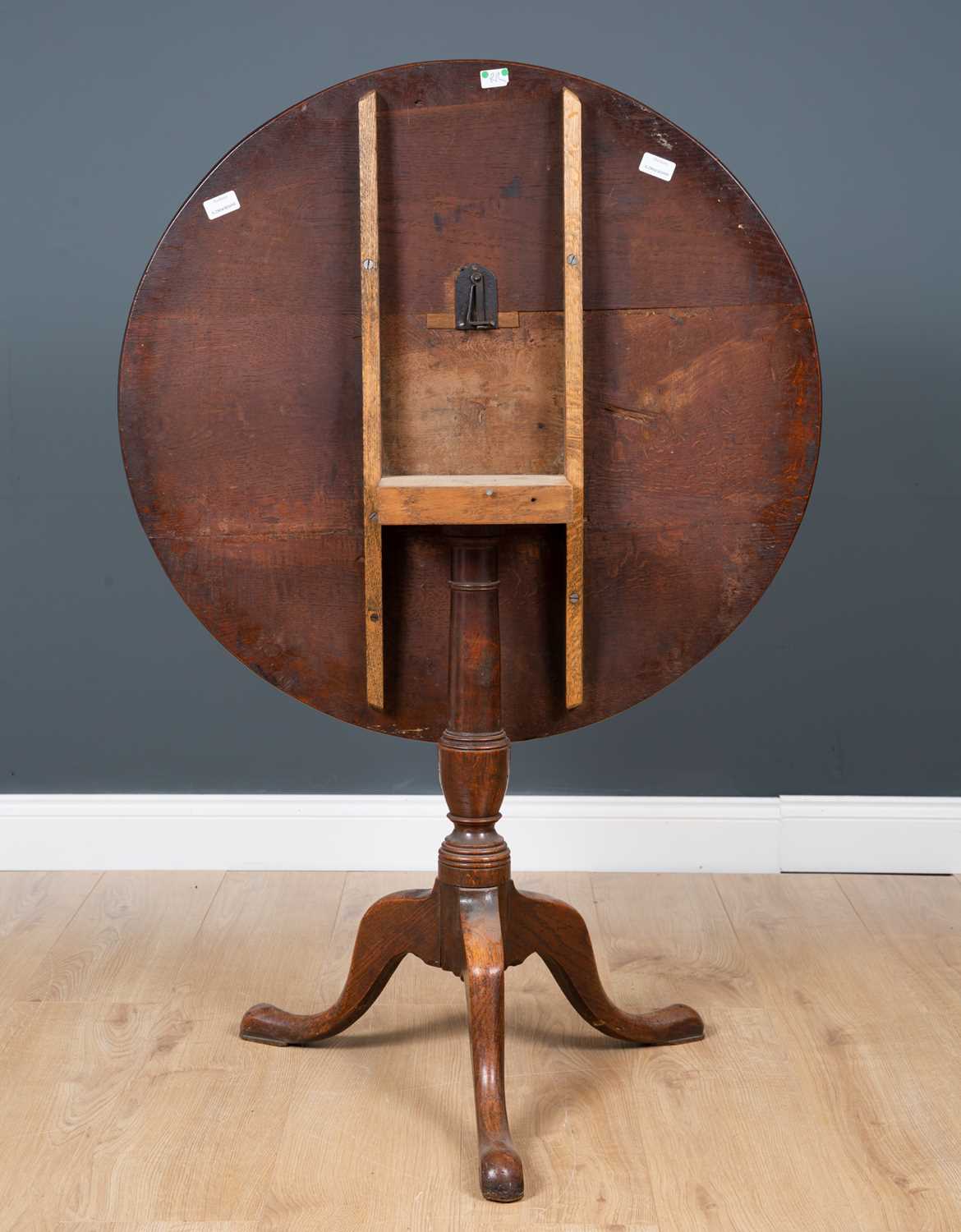 A George III oak circular tilt top tripod table with turned column support, 82cm diameter x 71.5cm - Image 3 of 3
