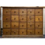 A modern pine chest of twenty drawers with turned knob handles, 138.5cm x 30cm x 99.5cm
