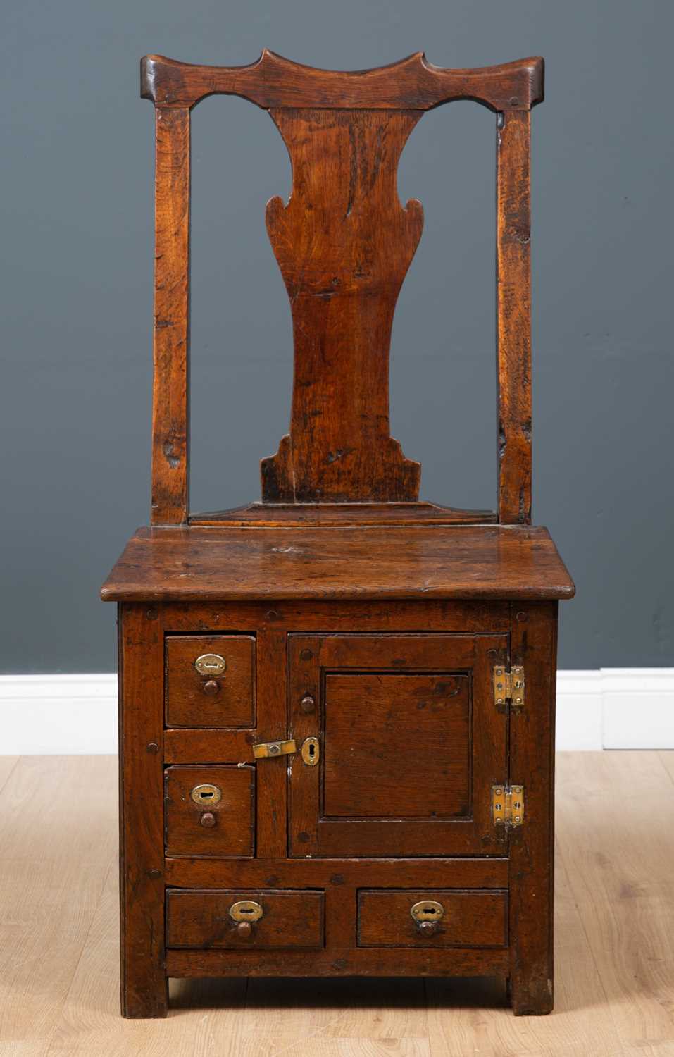 A George III Irish oak country chair possibly from Country Antrim, with solid bar shaped splat