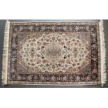 An Eastern cream ground rug with stylised foliate decoration, 188cm x 121cmCondition report: In