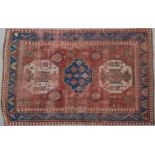 A Kazak red ground rug with geometric decoration, 257cm x 185cmCondition report: with moderate to