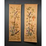 A near pair of early 20th century silk embroidered panels depicting flowers and exotic birds, each