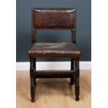 A late 17th / early 18th century oak leather upholstered side chair with bobbin turned legs united