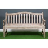 A 'Barlow Tyne' wooden one and a half seater garden bench with slatted seat back and seat and turned
