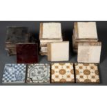 A box of assorted Victorian tiles some with foliate decoration, others with plain colours, stamped