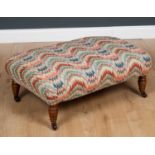 A Victorian footstool on turned legs with colourful zig-zag upholstery, 80cm wide x 56cm deep x 32cm