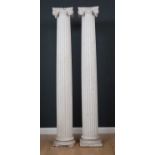 A pair of 19th century white painted tapered fluted plaster columns on plinth bases with Ionic