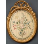 A Georgian silk embroidered picture depicting a posy of flowers, mounted in a gilded frame with a