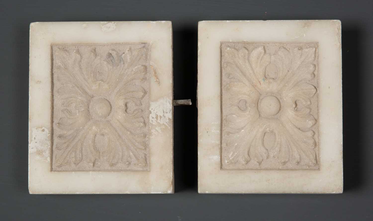 A pair of carved white marble chimney piece end blocks, 12cm wide x 9.5cm high (2)Condition