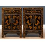 A pair of Oriental black lacquered bedside cabinets with gilded butterfly decoration, each 40cm wide