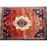 A Middle Eastern red ground rug with a banded border with geometric decoration, 198cm x