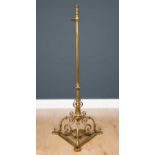 A late 19th century brass adjustable standard lamp with a triform base, 40cm wide at the base x