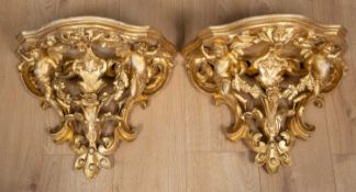 A pair of 19th century continental gilt carved wood wall brackets decorated with cherubs