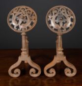 A pair of Victorian arts and crafts steel andirons the pierced finials decorated with dolphins and