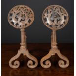 A pair of Victorian arts and crafts steel andirons the pierced finials decorated with dolphins and