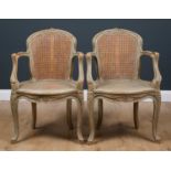 A pair of Louis XVI painted beechwood and caned fauteuil each with carved decoration, 54cm wide x