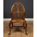 A Gothic style yew wood Windsor armchair manufactured by Stewart Linford in the 1980's, with