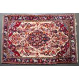 A late 20th century Middle Eastern woollen rug with a blue border, 203cm 134cmCondition report: In