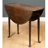 A 19th century oak small size oval drop leaf table on turned tapering legs terminating in club feet,