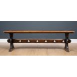 A Victorian oak bench with shaped end supports and trefoil punched stretcher, 153cm long x 30cm deep
