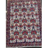 An early to mid 20th century Eastern polychrome rug with stylised foliate decoration, 150cm x
