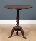 A George III country made mahogany circular tilt top occasional table with octagonal column