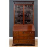 A George III mahogany bureau bookcase with pierced fretwork cornice, the astragal glazed doors